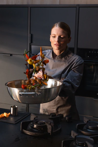 Chef tossing vegetables in Fissler pan