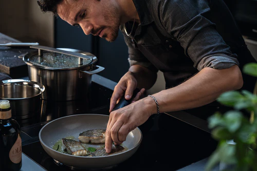 Chef plating fish with precision