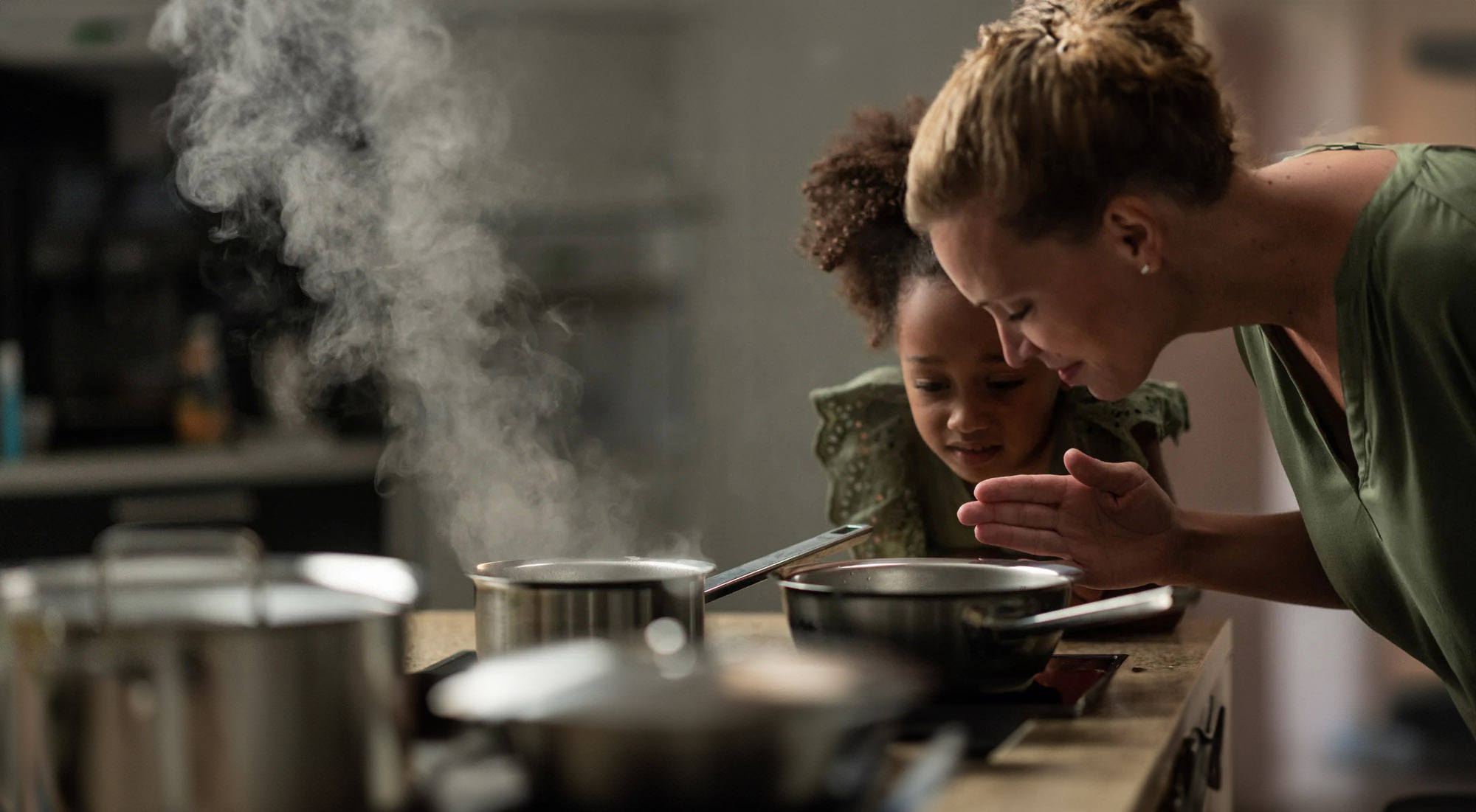 Mother and daughter cooking together
